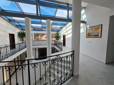 a staircase in a building with a glass ceiling at Atrium-Accomm in Řitka