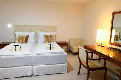a hotel room with a bed and a desk and a computer at Atrium-Accomm in Řitka