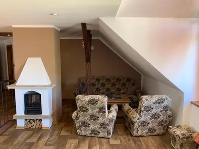 a living room with a couch and a fireplace at Penzion Na Růžku in Sedlčany