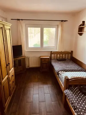 a bedroom with two twin beds and a window at Penzion Na Růžku in Sedlčany
