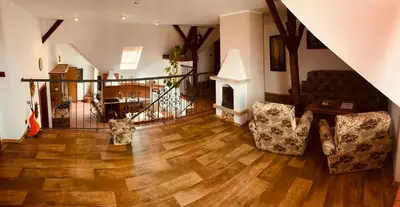 a living room with two chairs and a fireplace at Penzion Na Růžku in Sedlčany