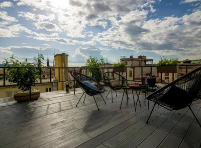 a patio with chairs and a table on a roof at Rooftop Planet Prague Hotel in Prague