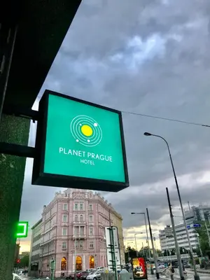 a sign for a planet temple hotel on a city street at Rooftop Planet Prague Hotel in Prague