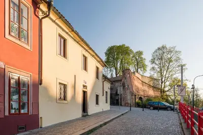 a cobblestone street in a town with buildings at Modern Apartment in a Picturesque 15th-Century Building in Prague