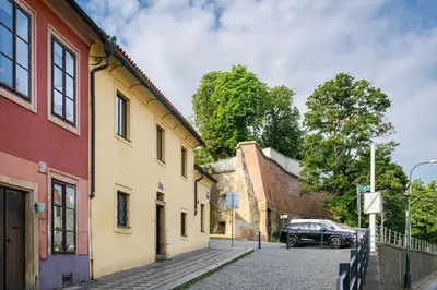 a street with buildings and a car parked on the street at Modern Apartment in a Picturesque 15th-Century Building in Prague