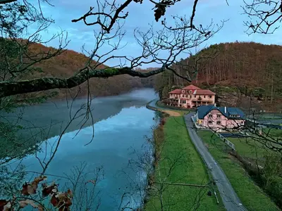 a river with houses on the side of it at penzion a kemp Harasov in Vysoká