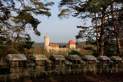 an old stone wall with a castle in the background at penzion a kemp Harasov in Vysoká
