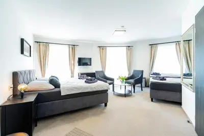 a bedroom with a bed and a living room at Restaurace Hotel Praha in Nižbor