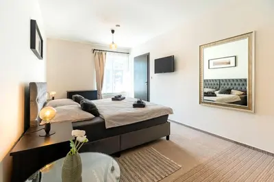 a bedroom with two beds and a mirror at Restaurace Hotel Praha in Nižbor