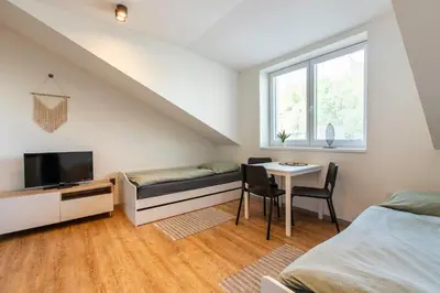 a bedroom with a bed and a table with a tv at Restaurace Hotel Praha in Nižbor