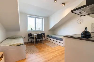 a small room with a bed and a table at Restaurace Hotel Praha in Nižbor