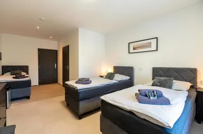 a hotel room with two beds and a desk at Restaurace Hotel Praha in Nižbor