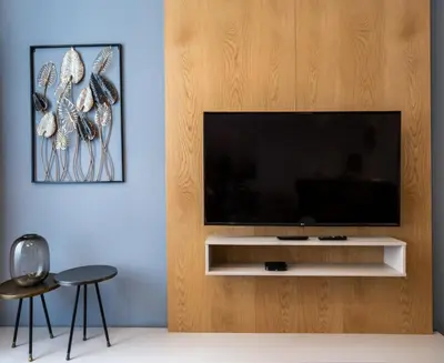 a living room with a flat screen tv on a wooden wall at Luxury Prague Riverside Apartment in Prague