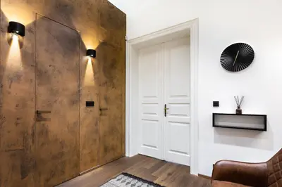 a room with a sliding door and a chair at Luxury Prague Riverside Apartment in Prague