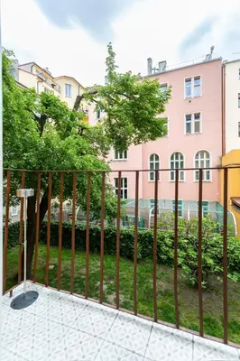 a fence in front of a building at Luxury Prague Riverside Apartment in Prague