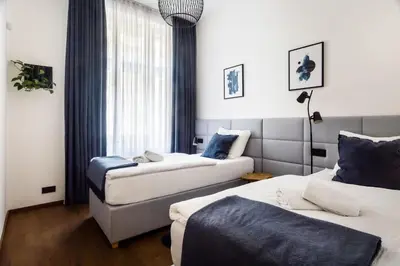 a hotel room with two beds and a window at Luxury Prague Riverside Apartment in Prague