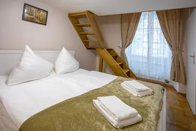 a bedroom with a bed with two towels on it at Michalska Apartment in Prague