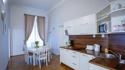 a kitchen and dining room with a table and a kitchen gmaxwell gmaxwell gmaxwell at Michalska Apartment in Prague