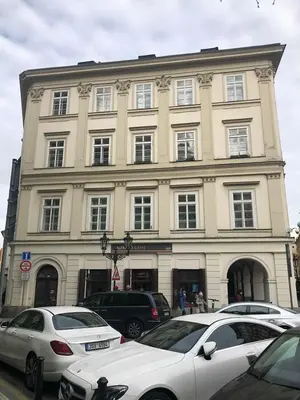 a large building with cars parked in front of it at Michalska Apartment in Prague