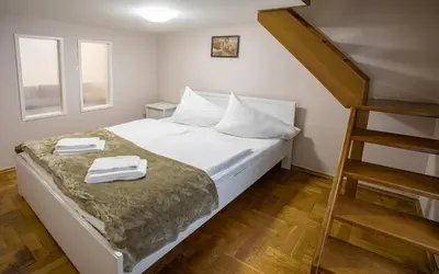 a bedroom with a bed with two towels on it at Michalska Apartment in Prague