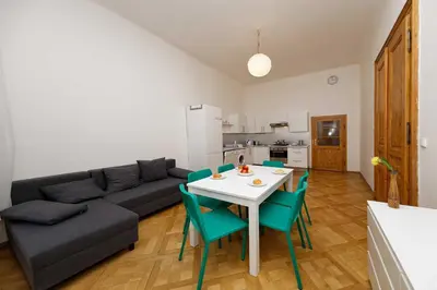 a living room with a couch and a table and chairs at Apartment Manesova 4 in Prague
