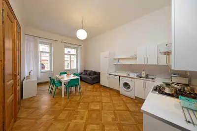 a kitchen and living room with a table and chairs at Apartment Manesova 4 in Prague
