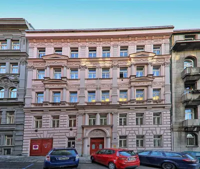 a large building with cars parked in front of it at Apartment Manesova 4 in Prague