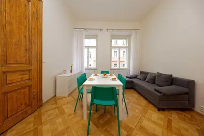 a living room with a table and chairs and a couch at Apartment Manesova 4 in Prague