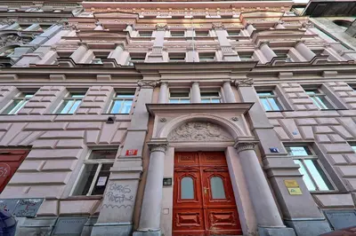 a tall building with a red door and windows at Apartment Manesova 4 in Prague