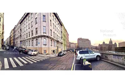 a city street with cars parked next to buildings at Apartment Manesova 4 in Prague