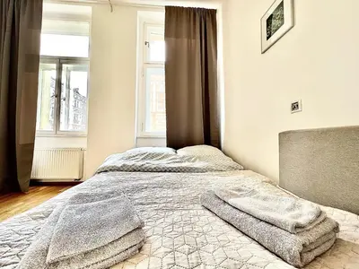 a bedroom with a bed with two towels on it at Maison Residence Prague in Prague