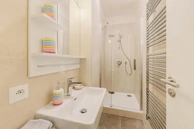 a white bathroom with a sink and a shower at Maison Residence Prague in Prague