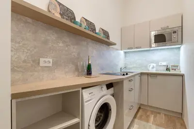 a kitchen with a washing machine and a sink at Maison Residence Prague in Prague