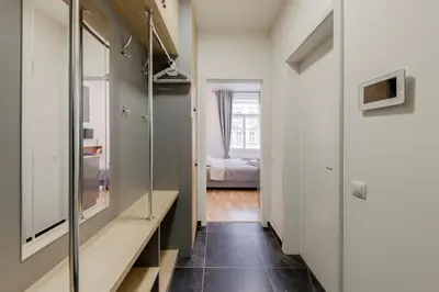 a bathroom with a mirror and a walk in closet at Maison Residence Prague in Prague
