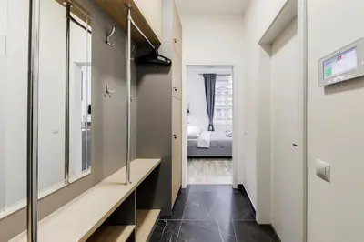 a hallway with a mirror and a dressing room at Maison Residence Prague in Prague