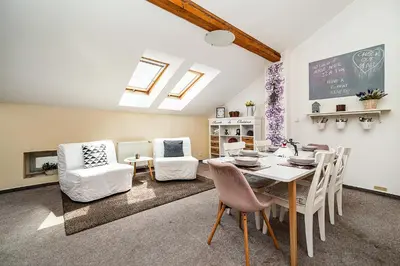a living room with a dining room table and chairs at LaNoblessa in Prague
