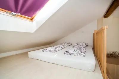 a bedroom with a bed in a attic at LaNoblessa in Prague
