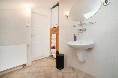 a bathroom with a sink and a mirror on the wall at LaNoblessa in Prague