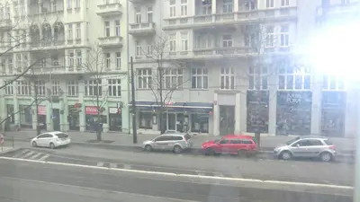 a group of cars parked on a city street at HU in Prague