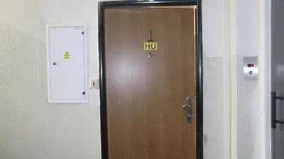 a wooden door with a hulu sign on it at HU in Prague