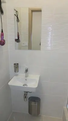a white bathroom with a sink and a mirror at HU in Prague