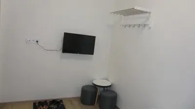 a room with two stools and a tv on a wall at HU in Prague