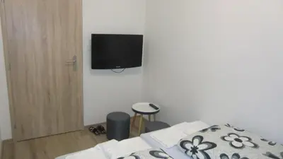 a bedroom with a bed and a tv on the wall at HU in Prague