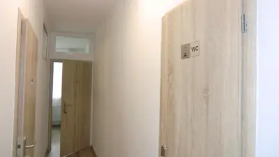 a hallway with a wooden door in a room at HU in Prague