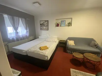 a small bedroom with a bed and a chair at Homestay U Hanky in Zdiby