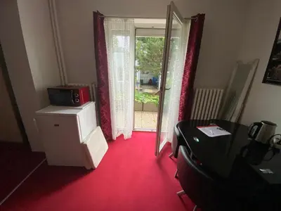 a room with a red floor and a door with a window at Homestay U Hanky in Zdiby