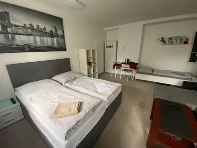 a bedroom with a bed and a table in it at Homestay U Hanky in Zdiby