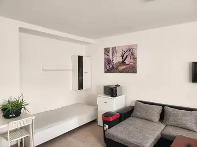 a living room with a couch and a chair at Homestay U Hanky in Zdiby