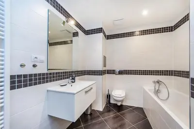 a bathroom with a sink and a toilet and a tub at REZIDENCE ŠVEHLOVA in Prague