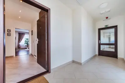 a hallway with a large door in a house at REZIDENCE ŠVEHLOVA in Prague